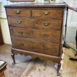 An oak chest on stand, having two short and three graduated long drawers, the stand with shaped