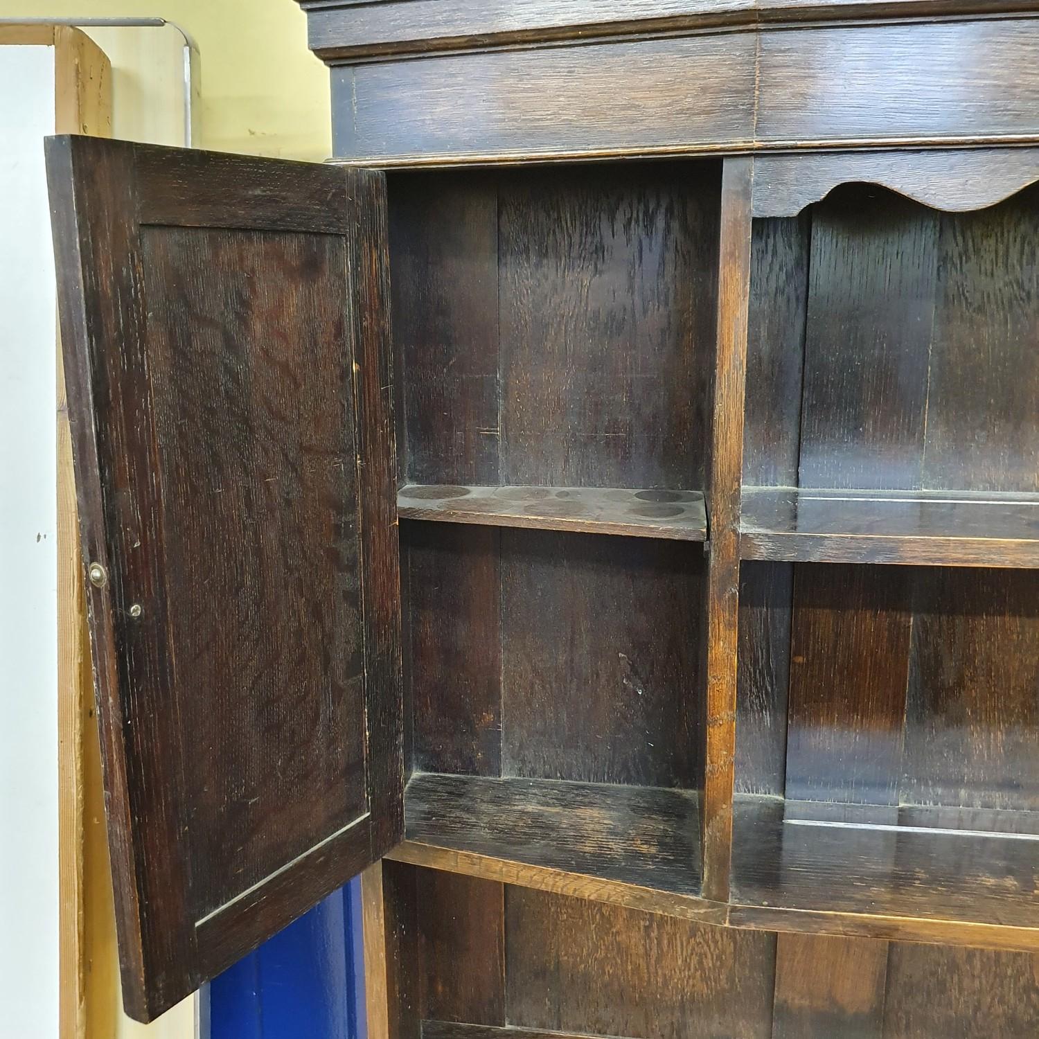 An oak dresser, top with two cupboard doors and two tier plate rack, base having two drawers and two - Image 5 of 5