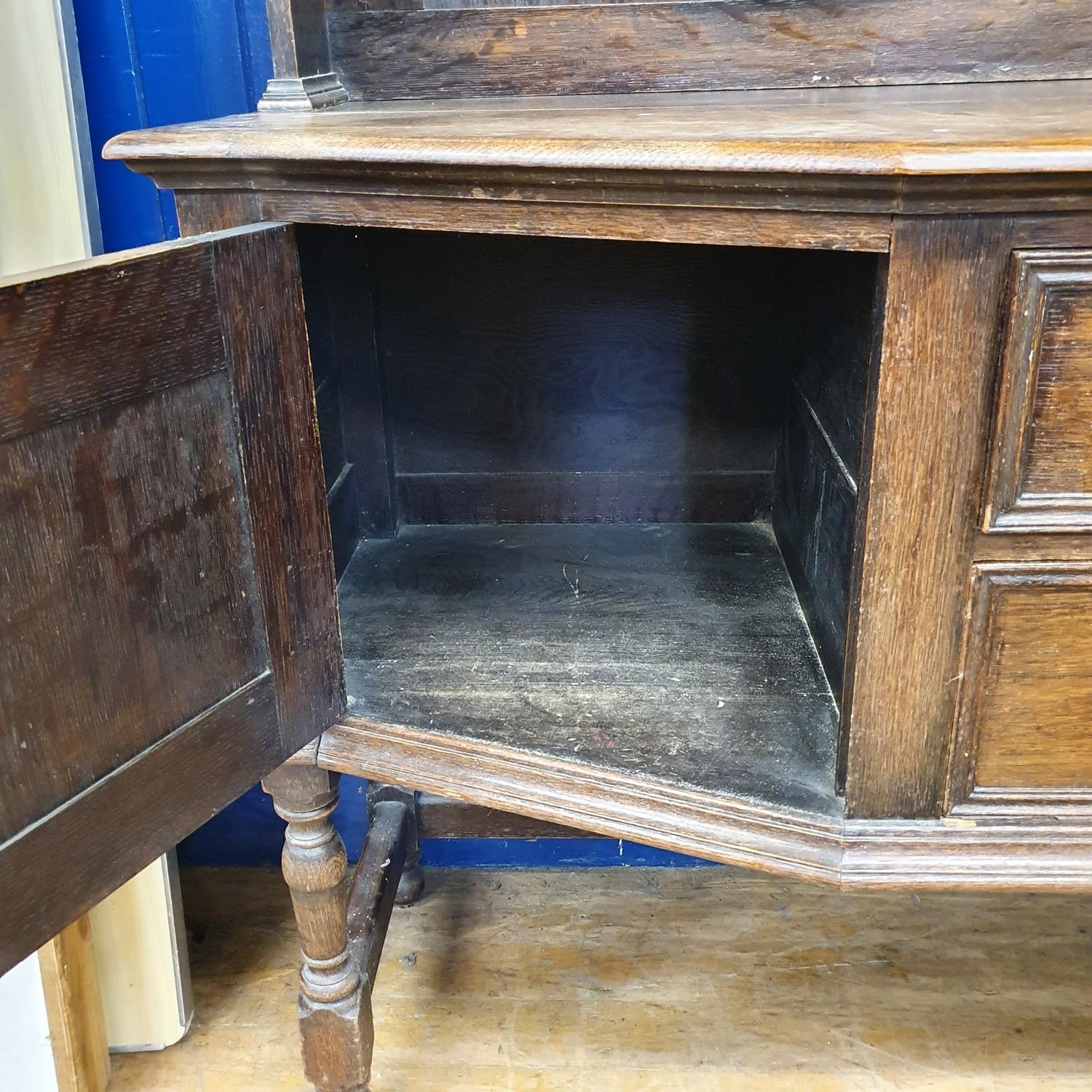 An oak dresser, top with two cupboard doors and two tier plate rack, base having two drawers and two - Image 3 of 5