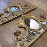 A pair of early 20th century over mantle mirrors, in Rococo manner with carved wood and gesso gilt