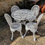 A painted metal garden table, 78 cm diameter and four matching chairs (5)