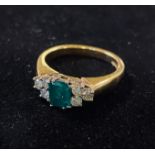 An 18ct gold, emerald and diamond cluster ring