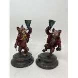 A pair of painted bronze candlesticks, in the form of a fox and a bear, 18 cm (2) Modern