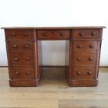 A 19th century mahogany kneehole desk, having a configuration of nine drawers, 124 cm wide