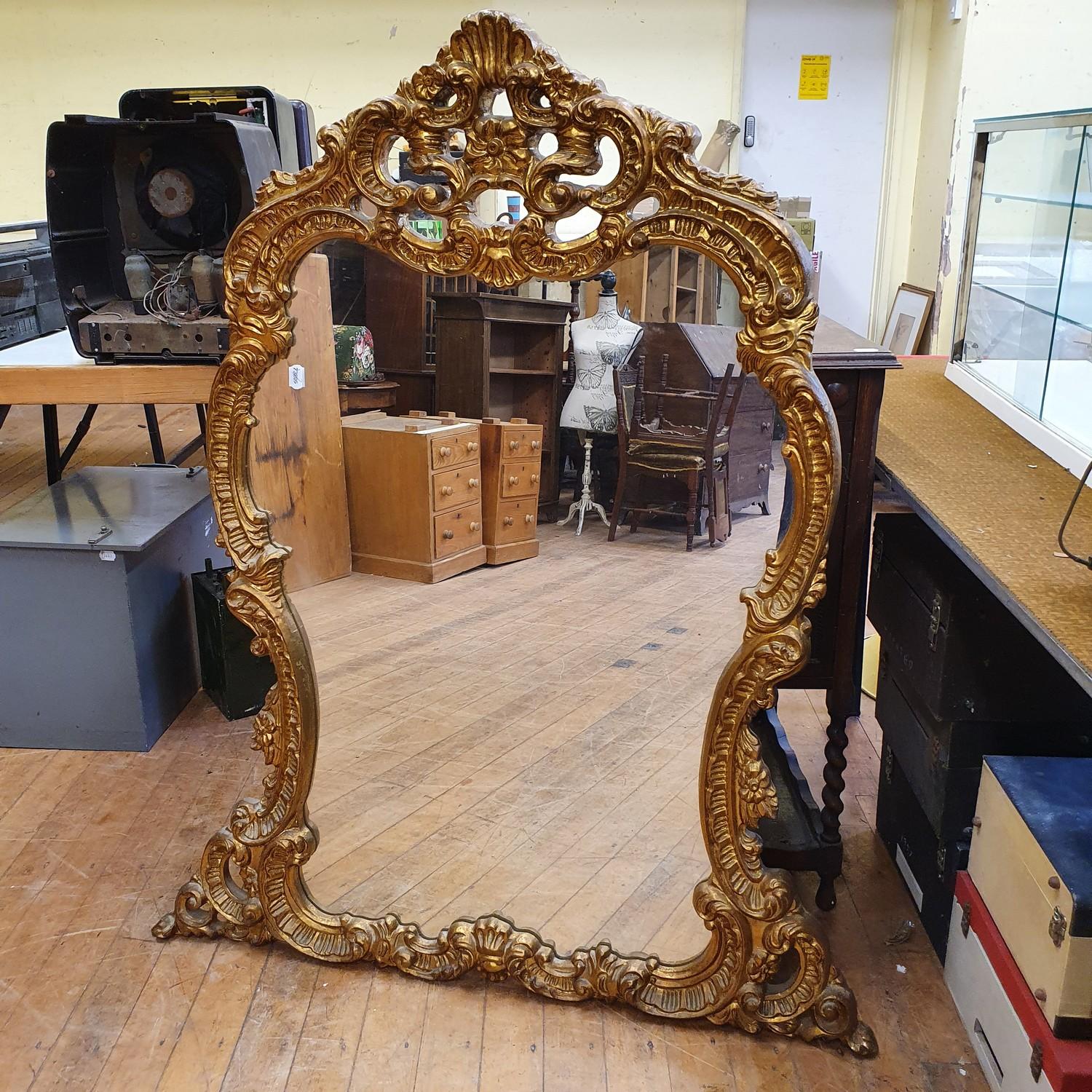 A rococo style gilt gesso wall mirror, 130 x 103 cm