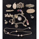 A silver charm bracelet, brooches and other items