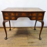 A walnut kneehole dressing table, 97 cm wide, an oak coffee table, and a pair of brass and faux wood