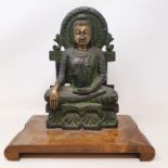 A bronze Buddha, seated on a throne, on a wooden stand, 27 cm high