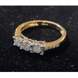 A 9ct gold and three stone diamond ring, with diamond shoulders Modern
