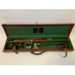 A canvas and leather shotgun case, with accessories to include a cleaning rod, and two J. Purdey &