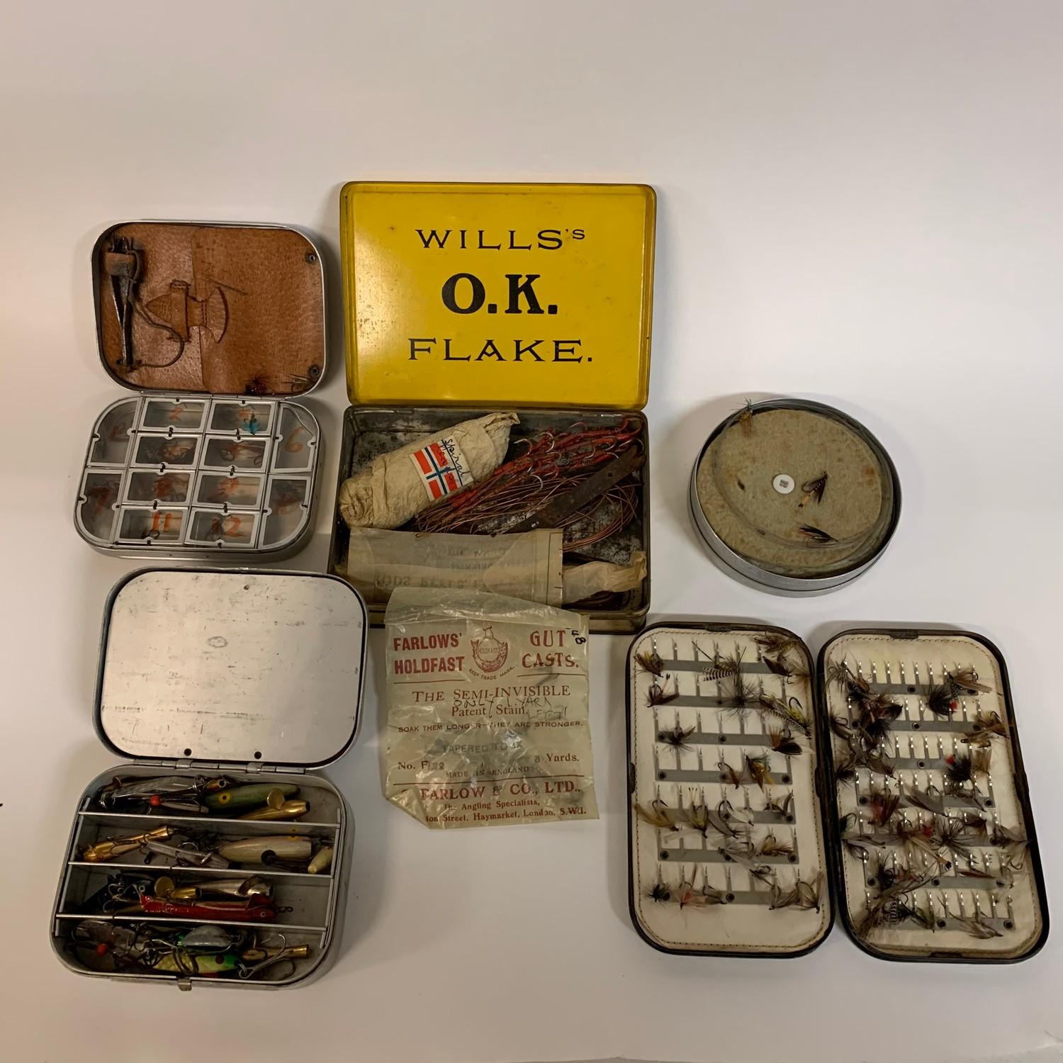 Assorted fishing lures, a leather reel box, a Hardy's cardboard box, various fly tins, and other