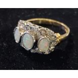 A 9ct gold, three oval stone opal and diamond ring Modern