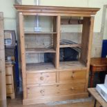 A pine wardrobe, with two cupboard doors, above two short and one long drawer, 150 cm wide, and a