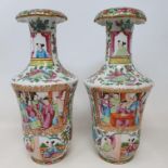 A pair of Chinese famille rose vases, of waisted form, decorated figures and foliage, some