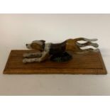 A painted bronze running hound dog paper clip, on an oak base, 28 cm wide Modern