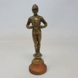 A brass jockey car mascot, 13.5 cm high, on a later turned wood base, 16.5 cm high (overall)