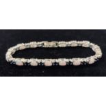A silver sapphire and opal line bracelet Modern