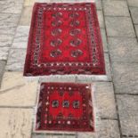 A red ground Afghan rug, 145 x 108 cm, and another 62 x 55 cm (2)