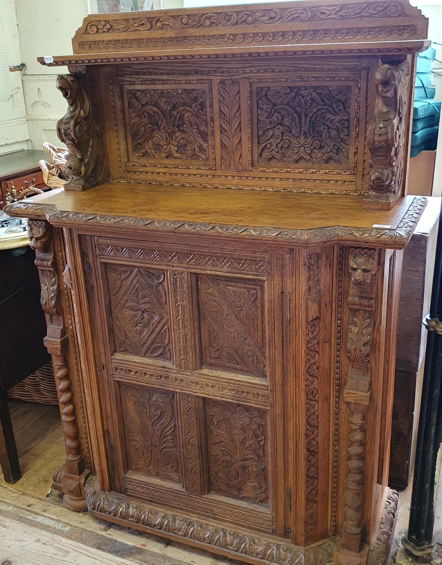 A late 19th century Anglo-Flemish oak cabinet, the raised back above a panel door, carved all over - Bild 2 aus 6