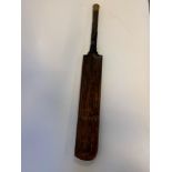 A cricket bat, the reverse applied a shield shaped plaque inscribed Presented to Charles Lancaster