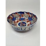 A pair of Japanese Imari plates, 31 cm diameter, a similar bowl, 28 cm diameter, another bowl, 11 cm