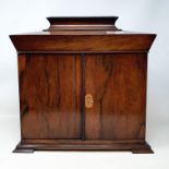 A Victorian rosewood table top cabinet, the lift up top above a pair of panel doors enclosing