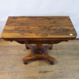 A 19th century rosewood folding card table, on a carved support shape base with bun feet, 92 cm wide