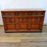 An 18th century style oak dresser base, having three drawers, above three cupboard doors, 157 cm