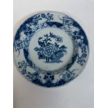 A Chinese blue and white plate, 23 cm diameter, restored, five other Chinese plates, and a delft