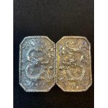 A Chinese silver coloured metal buckle, decorated dragons, 5.5 cm high