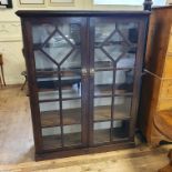 An oak glazed bookcase, 110 cm wide, and a mahogany shelf, 120 cm wide (2)