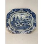 An early 19th century Chinese meat plate, decorated dwellings and flowers in underglaze blue, 45.5