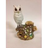 A Moore Brothers figure of a long eared owl, perched on a branch, impressed mark to base, 33 cm high