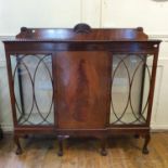 A mahogany breakfront display cabinet, having single panel doors flanked by two glazed doors on