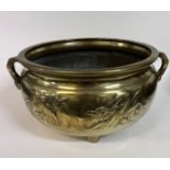 A large Chinese brass censer, decorated dragons chasing flaming pearls, with bamboo handles, 42 cm