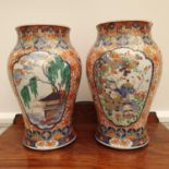 A pair of Japanese Imari vases, of inverted baluster form, decorated figures and foliage, 30 cm high