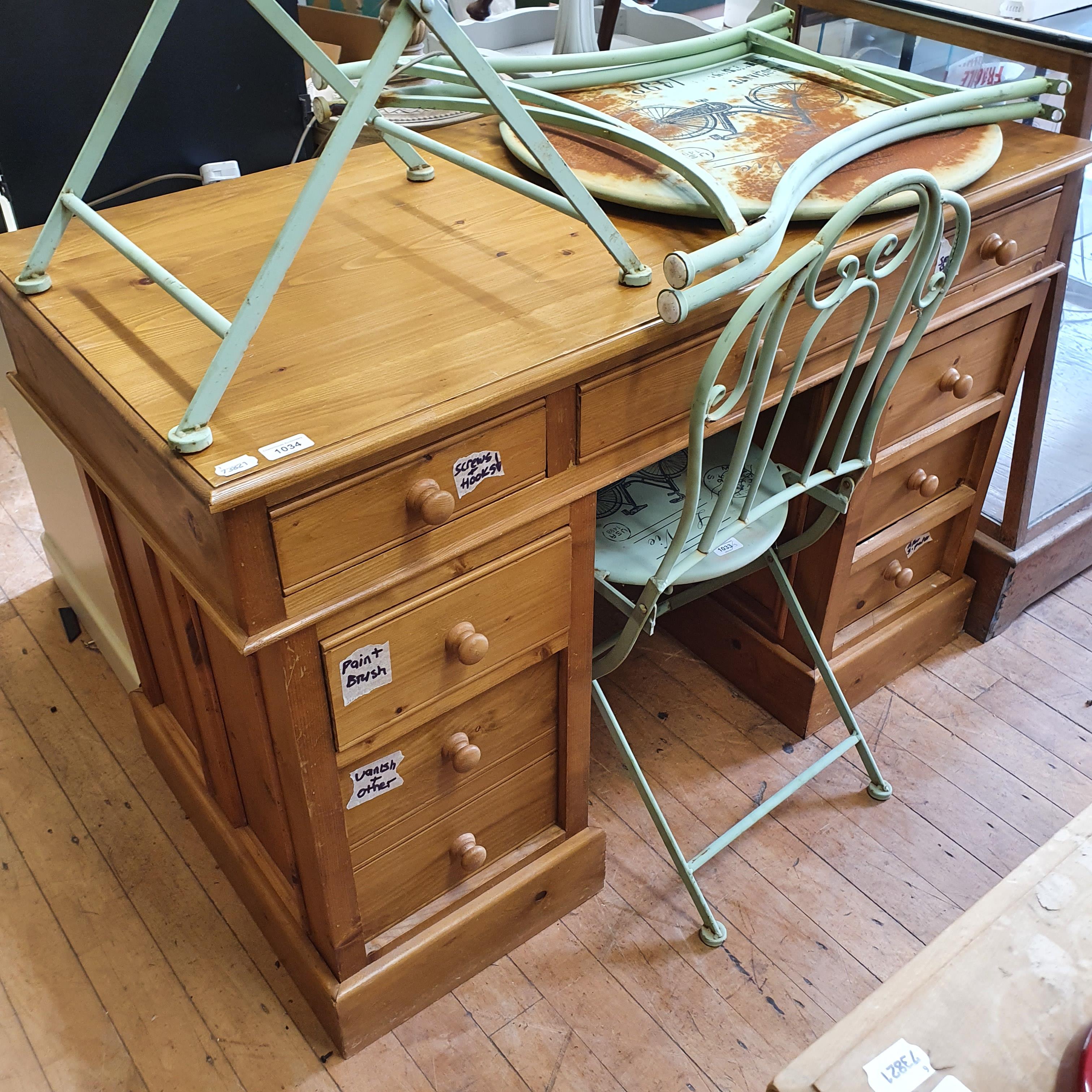 A pine pedestal desk, having nine drawers, 121 cm wide