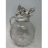 A glass Pimms or lemonade jug, with boar head plated mounts, 28 cm high Modern