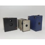 A Kodak No. 2 Brownie box camera, in gold, with canvas case, an Ensign E29 box camera, in blue, with