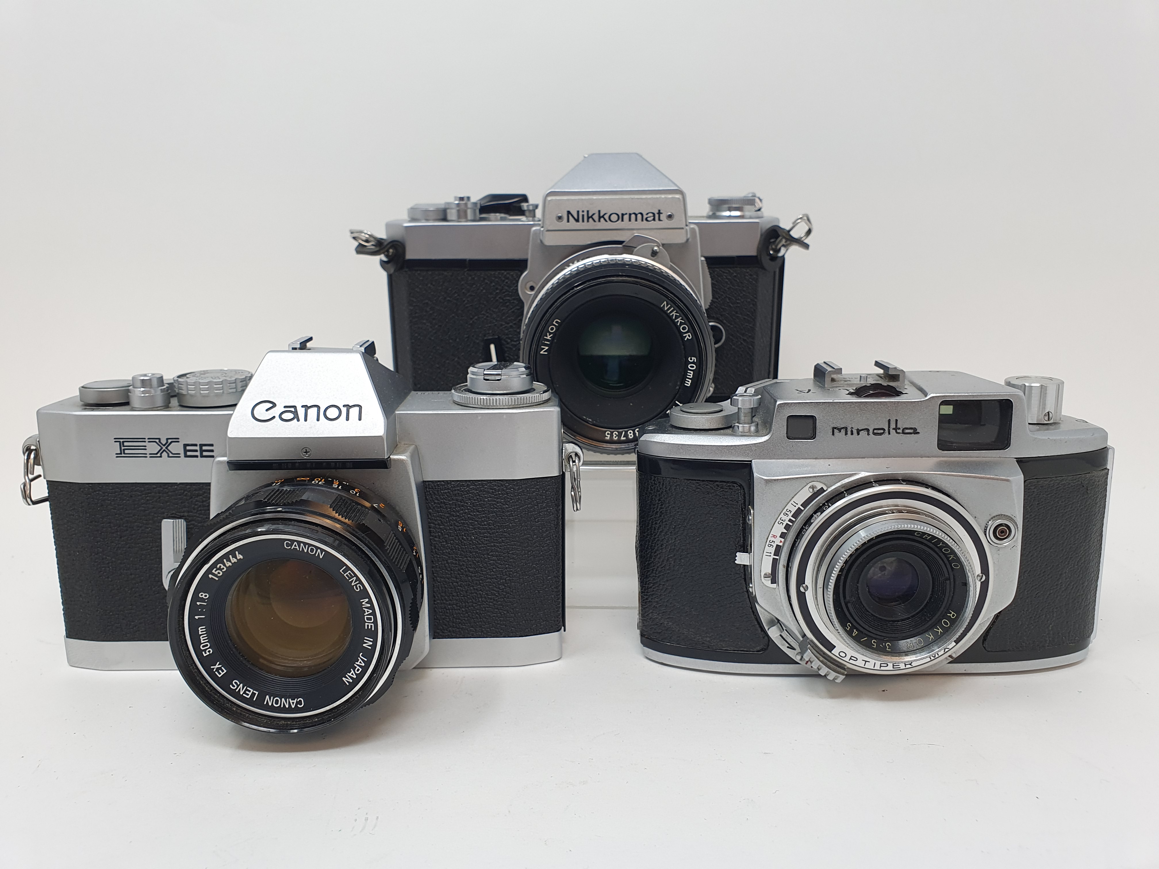 A Nikkormat Nikon, a Minolta A camera and a Canon EX EE camera (3) Provenance: Part of a vast single