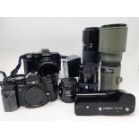 A Minolta 9000 camera, a Minolta 7000 camera, various lenses and accessories in a carrying case