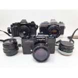 A Minolta XG 1 camera, with outer case, and a Minolta SRT 303p camera, with outer case, and a