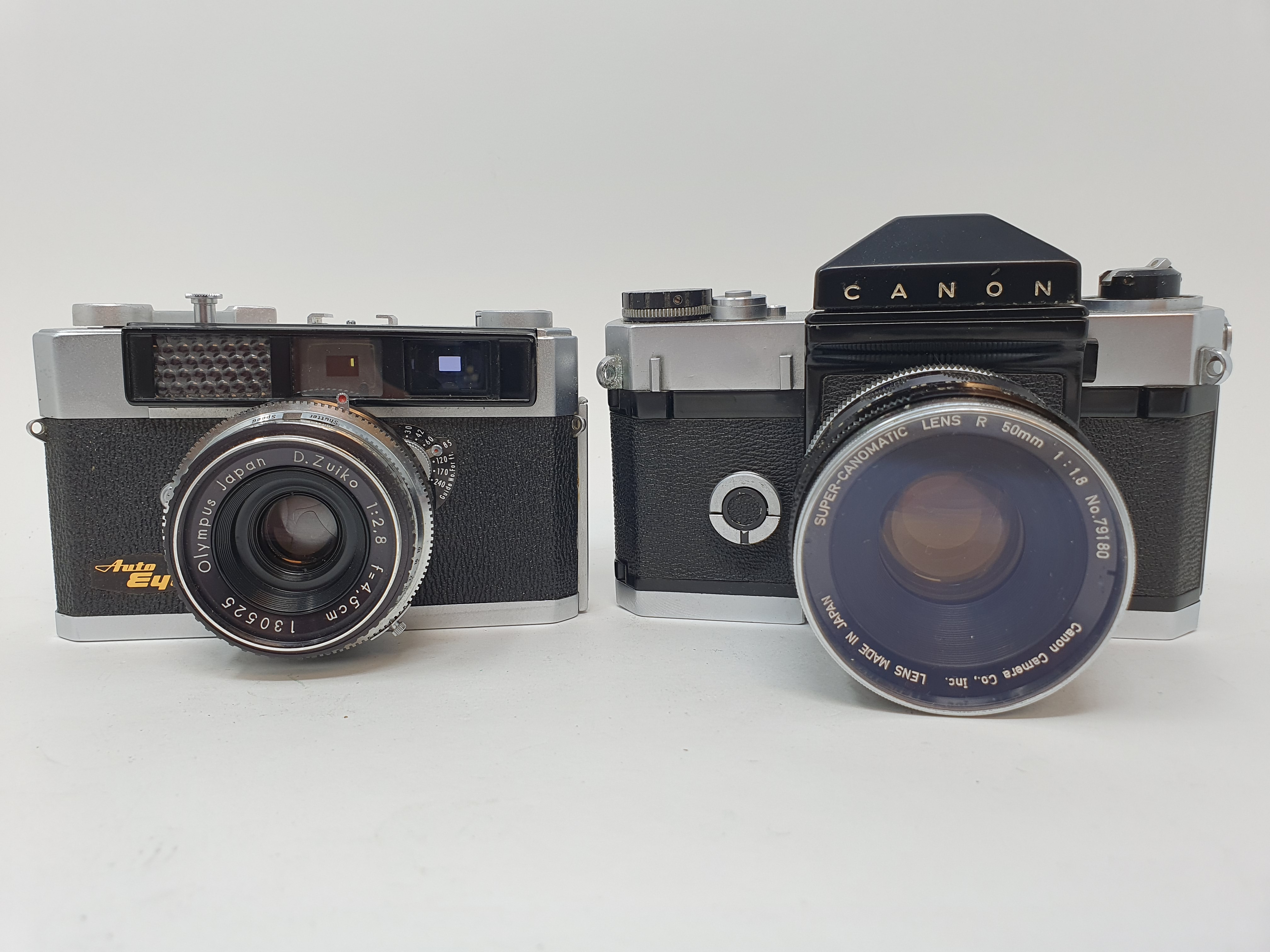 An Olympus camera, serial number 126947 and a Canon Canonflex camera (2) Provenance: Part of a