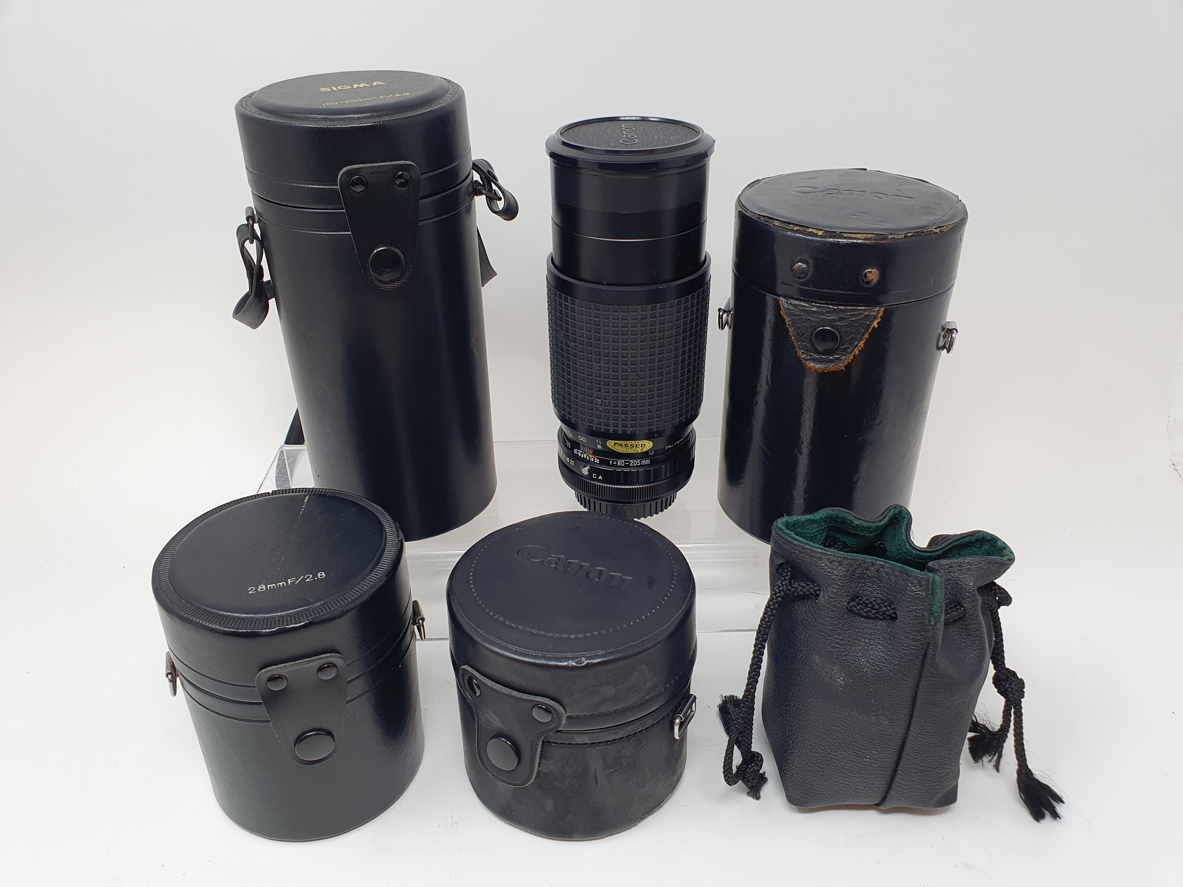 A Sigma camera lens, in outer case, another, three Canon lenses, and a Canon flash, in leather - Image 9 of 10