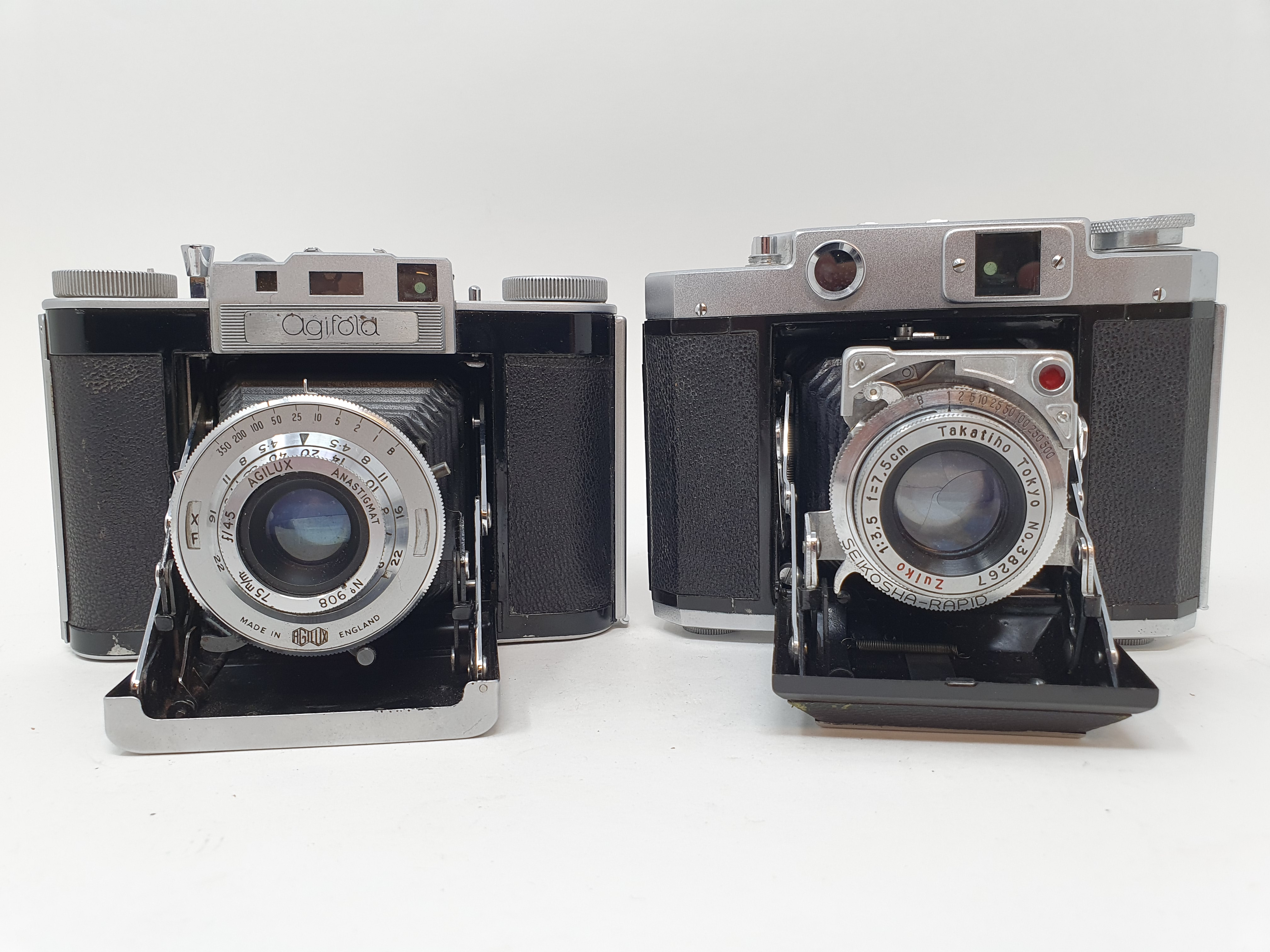 A Mamiya-6 folding camera, with leather outer case, and an Agiwx Agifold folding camera, with