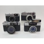 An Olympus Trip 35 camera, an Olympus - PEN camera a Fujica GER camera and a Minolta AL - F