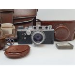 A Reid & Sigrist ltd camera, serial number P2750, with leather outer case, lens, and accessories