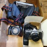 An Olympus OM-1, with lens, boxed, and a Canon EOS-1 camera, and lens, and other items, and a camera