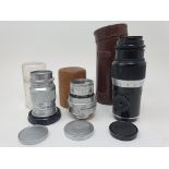 A Leica camera lens, in leather outer case, and two other Leica lenses (3) Provenance: Part of a