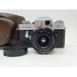 A Leica Leicaflex camera, serial number 1115659, with leather outer case Provenance: Part of a